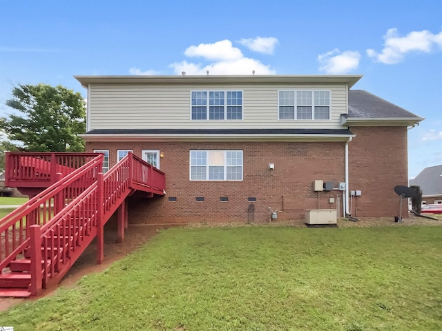 back of house with stairway, a yard, a wooden deck, and brick siding