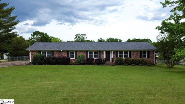ranch-style house featuring brick siding and driveway