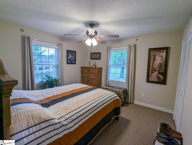 bedroom with carpet flooring, baseboards, a ceiling fan, and a textured ceiling