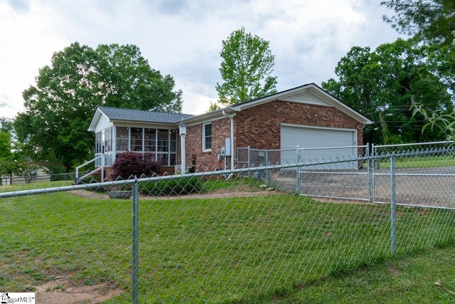 ranch-style house featuring brick siding, a sunroom, a garage, and driveway