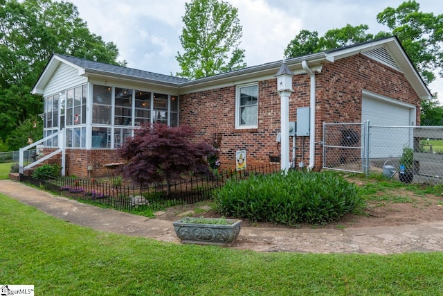 view of property exterior featuring brick siding, a sunroom, fence, and a garage
