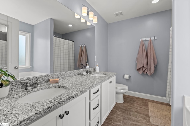 full bath featuring baseboards, wood finished floors, double vanity, toilet, and a shower with shower curtain
