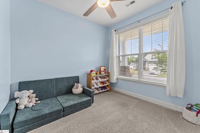 recreation room with carpet floors, baseboards, and ceiling fan