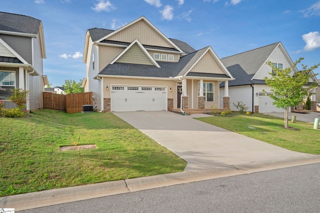craftsman house with board and batten siding, stone siding, concrete driveway, and roof with shingles