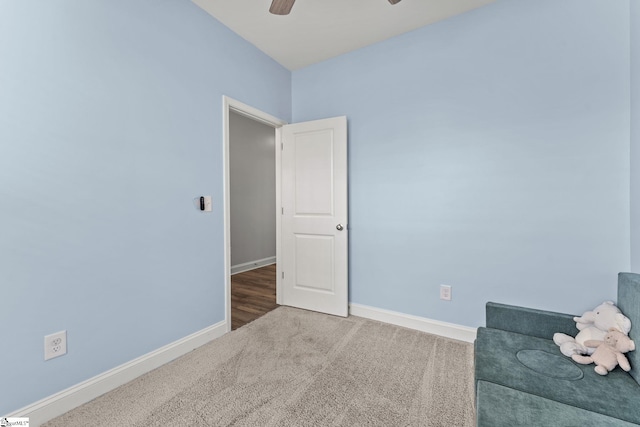sitting room with carpet flooring, baseboards, and ceiling fan