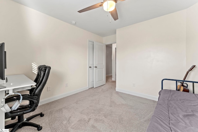 carpeted home office featuring ceiling fan and baseboards