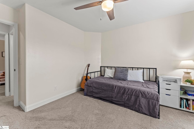 carpeted bedroom with baseboards and ceiling fan