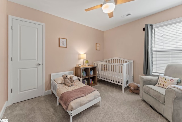 bedroom featuring carpet, multiple windows, and ceiling fan