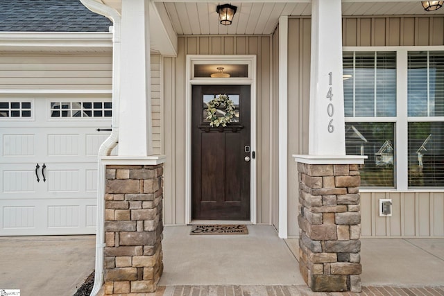 entrance to property featuring stone siding, a shingled roof, and covered porch