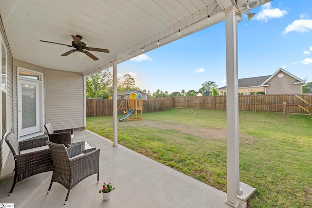 view of patio featuring a ceiling fan and a playground