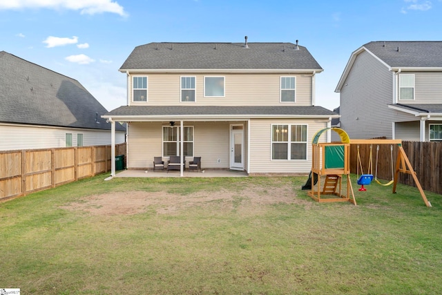 rear view of property featuring a playground, a patio, and ceiling fan