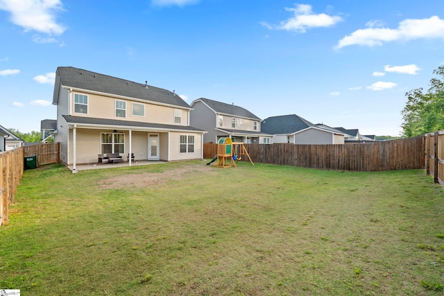 rear view of property with a patio area, a playground, and a ceiling fan