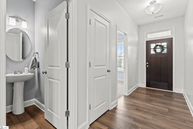 entrance foyer with dark wood finished floors and baseboards