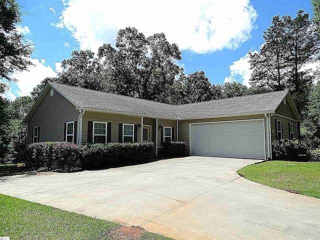 ranch-style house featuring an attached garage and driveway