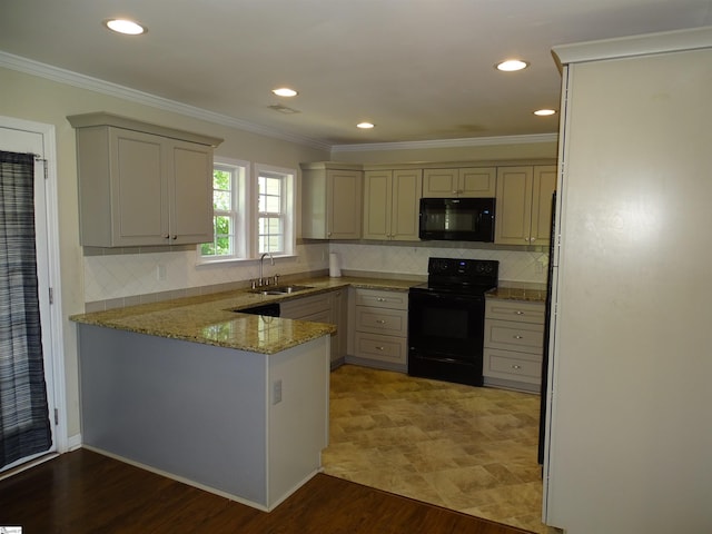 kitchen with black appliances, a sink, a peninsula, ornamental molding, and light stone countertops