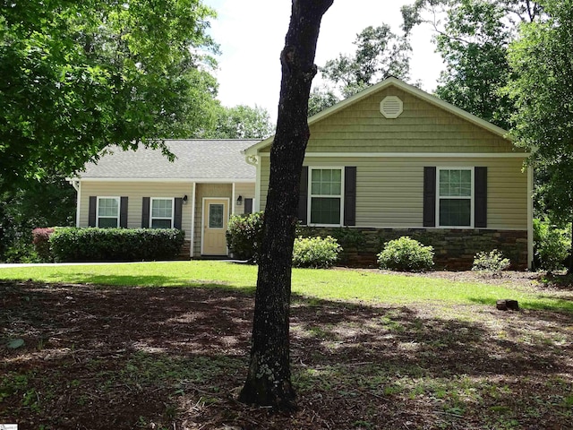 view of front of property featuring stone siding and a front yard