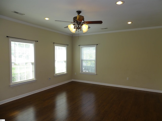spare room featuring plenty of natural light, baseboards, dark wood-style floors, ornamental molding, and recessed lighting
