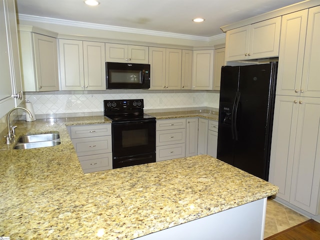 kitchen with black appliances, a sink, light stone countertops, decorative backsplash, and ornamental molding