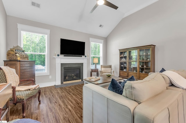107 Summer Oak Ln, Simpsonville, SC 29680 - living room featuring lofted ceiling, ceiling fan, wood finished floors, a glass covered fireplace, and baseboards