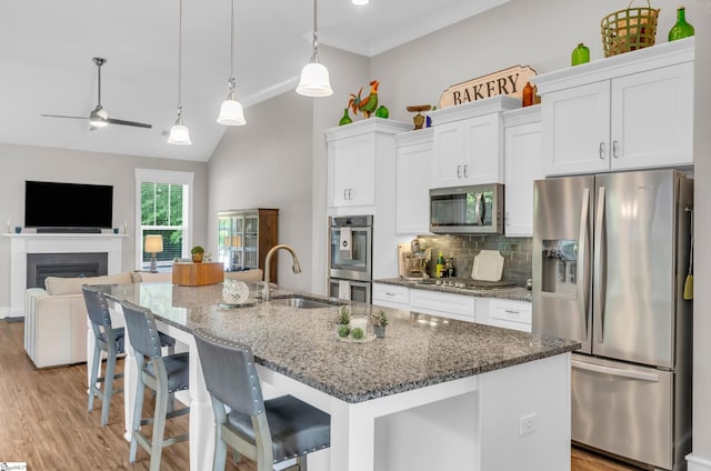 107 Summer Oak Ln, Simpsonville, SC 29680 - kitchen featuring appliances with stainless steel finishes, a sink, white cabinetry, backsplash, and light wood-style floors