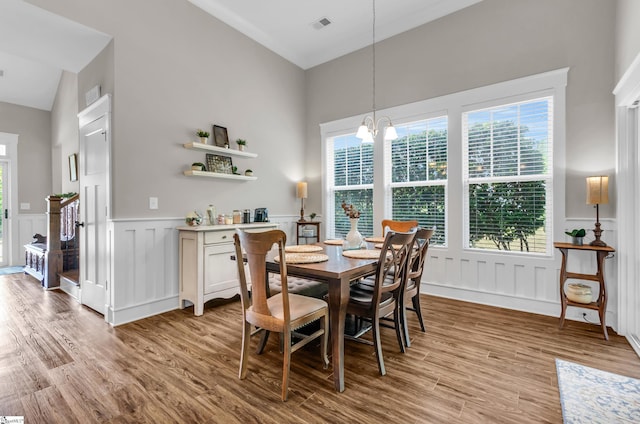 107 Summer Oak Ln, Simpsonville, SC 29680 - dining area with a decorative wall, light wood-style floors, a chandelier, and wainscoting
