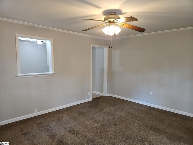 empty room with crown molding, ceiling fan, dark carpet, and baseboards