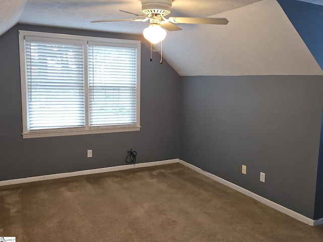 additional living space featuring ceiling fan, lofted ceiling, carpet, and baseboards
