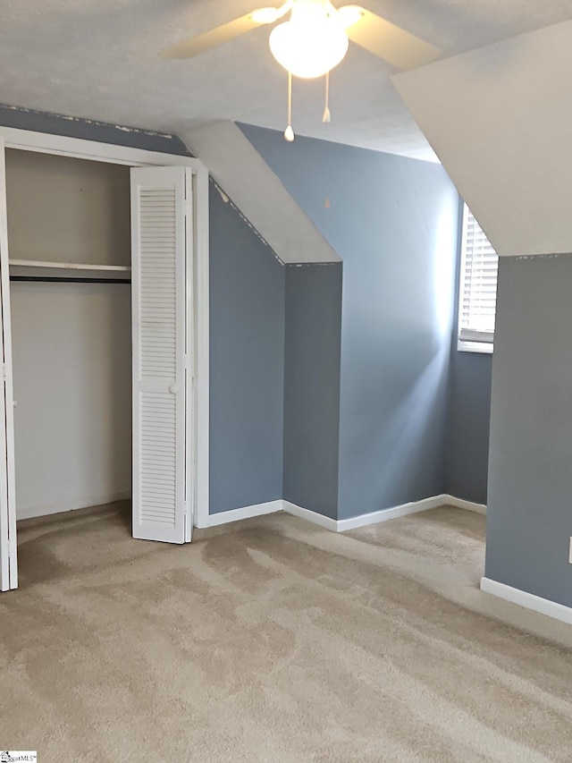 bonus room featuring carpet flooring, a ceiling fan, lofted ceiling, and baseboards