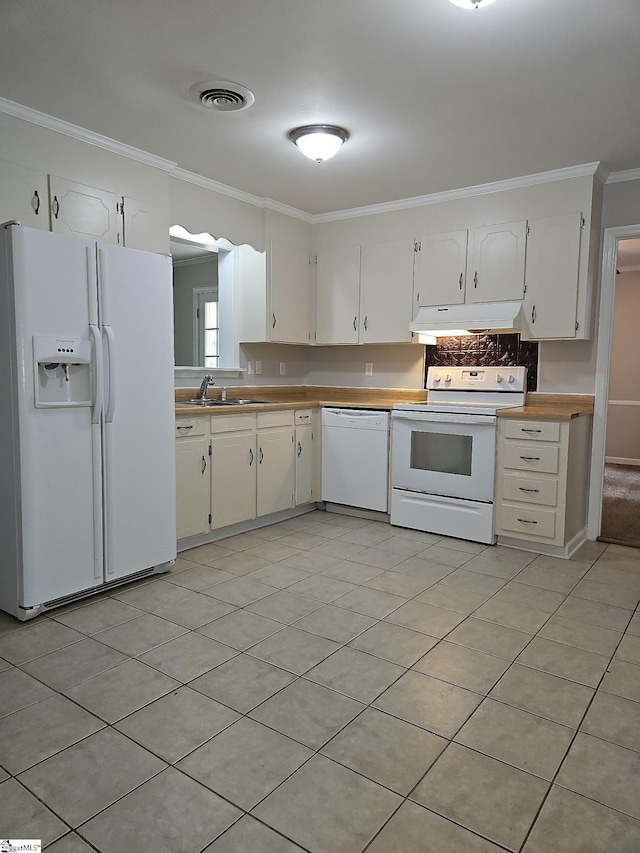 kitchen with white appliances, under cabinet range hood, a sink, ornamental molding, and white cabinets