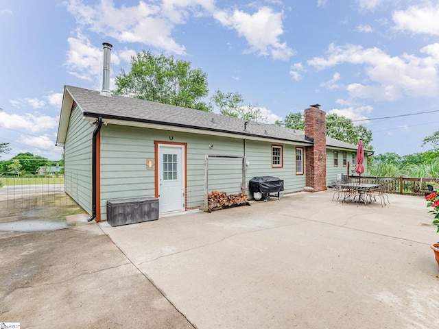 1312 Anderson Hwy, Easley, SC 29642 - rear view of house with a patio area, fence, a shingled roof, and outdoor dining area