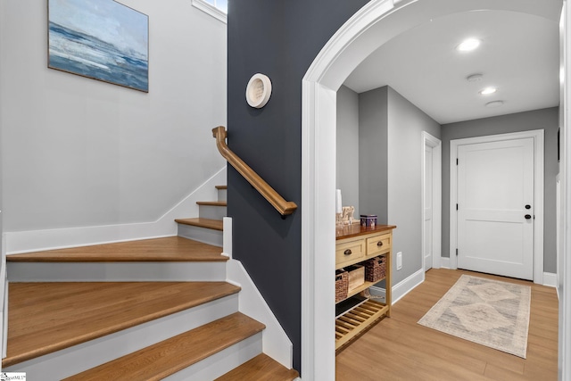 114 Burrough St, Greenville, SC 29615 - stairway with arched walkways, wood finished floors, and baseboards