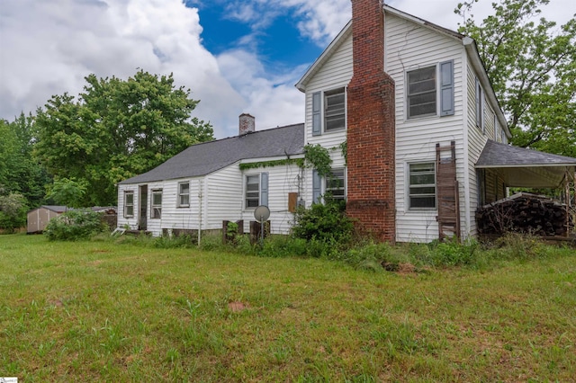 156 Spencer Rd, Jonesville, SC 29653 - back of house featuring a chimney, a yard, and an attached carport