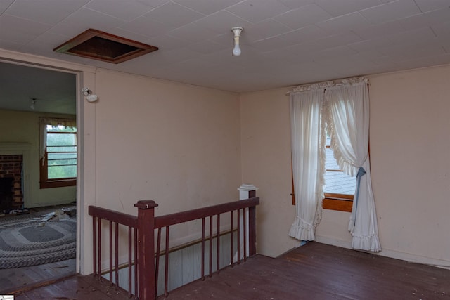 156 Spencer Rd, Jonesville, SC 29653 - empty room with wood finished floors and a brick fireplace