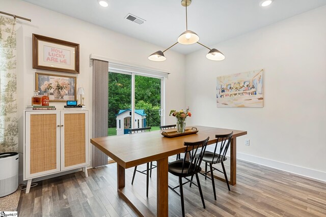 dining area featuring wood finished floors, recessed lighting, and baseboards