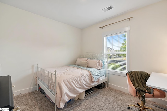 bedroom featuring baseboards and carpet