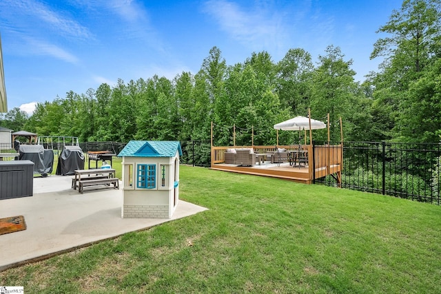 view of yard with an outdoor living space and a wooden deck