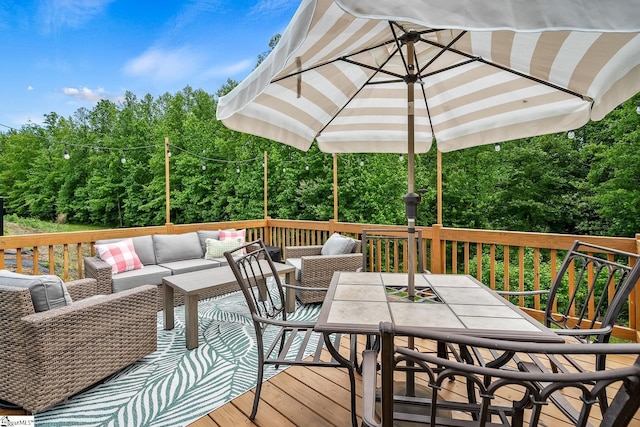 wooden terrace featuring an outdoor hangout area and outdoor dining space