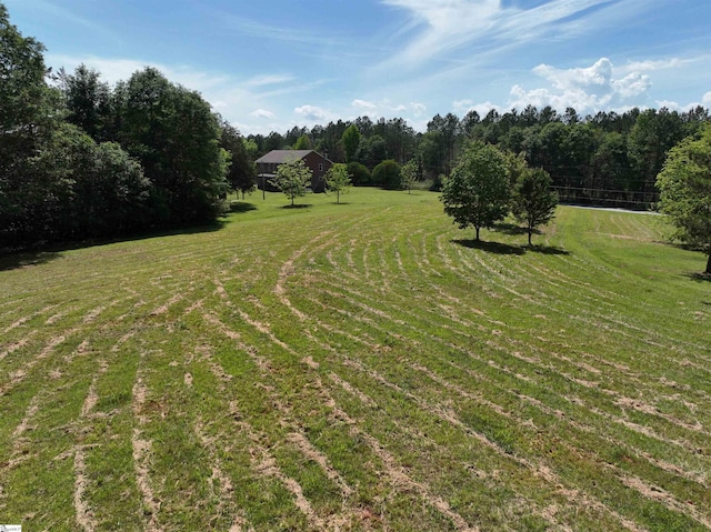 view of green lawn featuring a view of rural / pastoral area