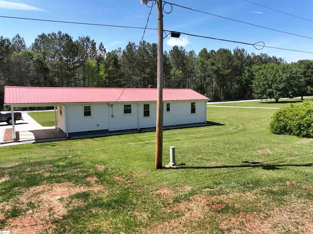 view of front facade featuring a front lawn and metal roof