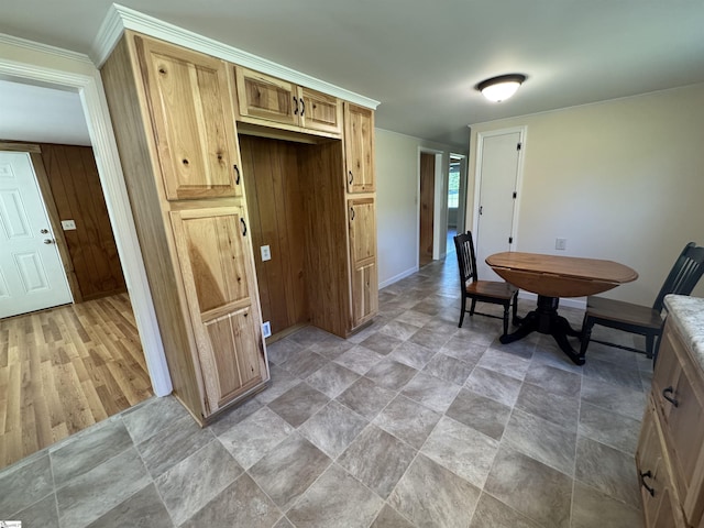 kitchen with baseboards and stone finish floors