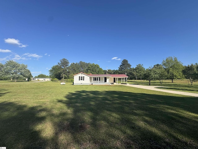 view of front facade featuring a front lawn and a carport