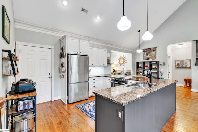 142 Stillcountry Cir, Travelers Rest, SC 29690 - kitchen with freestanding refrigerator, a sink, stone counters, white cabinetry, and decorative light fixtures