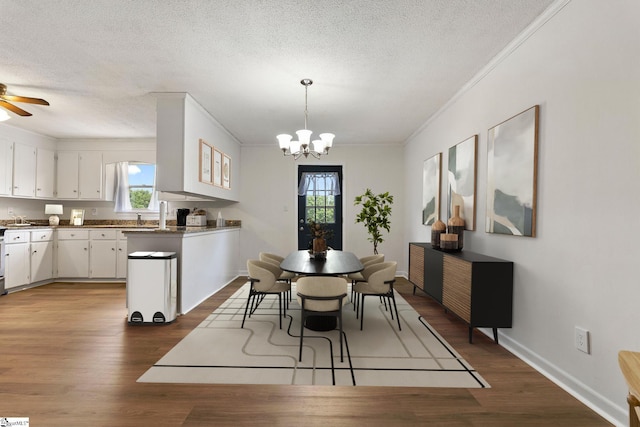 205 Woodfield Dr, Piedmont, SC 29673 - dining area featuring crown molding, plenty of natural light, dark wood-style floors, a textured ceiling, and a chandelier