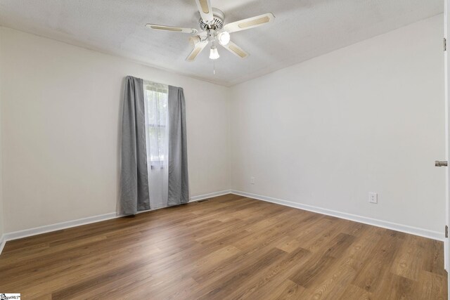 205 Woodfield Dr, Piedmont, SC 29673 - unfurnished room with wood finished floors, a ceiling fan, and baseboards