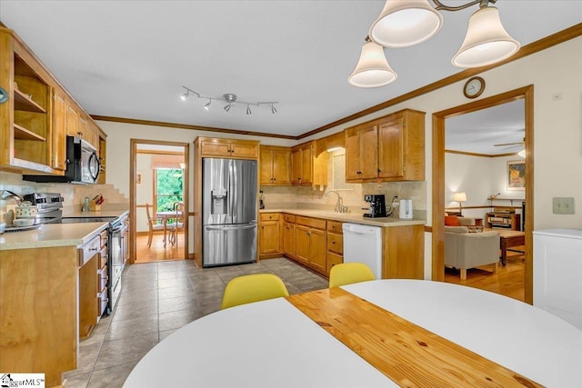 111 Golf View Ln, Greenville, SC 29609 - kitchen with appliances with stainless steel finishes, crown molding, backsplash, light countertops, and a sink