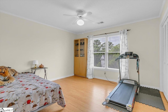 111 Golf View Ln, Greenville, SC 29609 - bedroom with baseboards, light wood-style floors, crown molding, a closet, and a ceiling fan