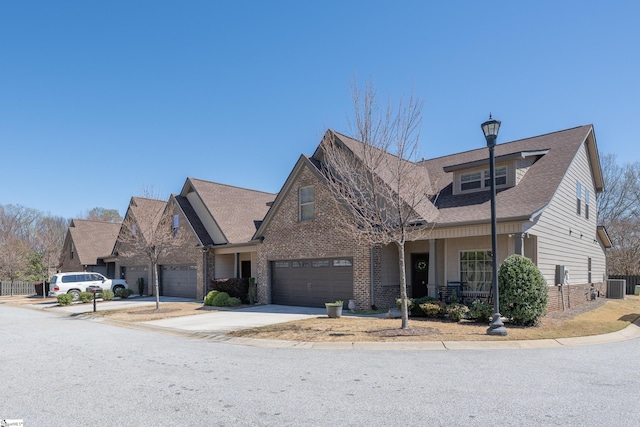 9 Sweetspire Ln, Simpsonville, SC 29681 - view of front of house with central AC unit, concrete driveway, brick siding, a shingled roof, and a garage