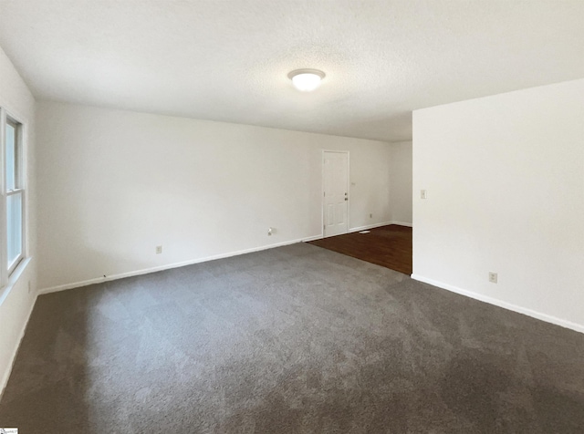 245 Rigby Ave, Spartanburg, SC 29306 - empty room featuring dark carpet, baseboards, and a textured ceiling