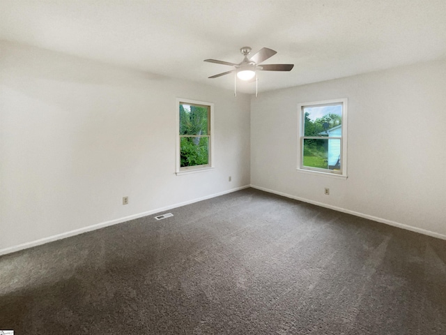245 Rigby Ave, Spartanburg, SC 29306 - empty room with plenty of natural light, a ceiling fan, dark colored carpet, and baseboards