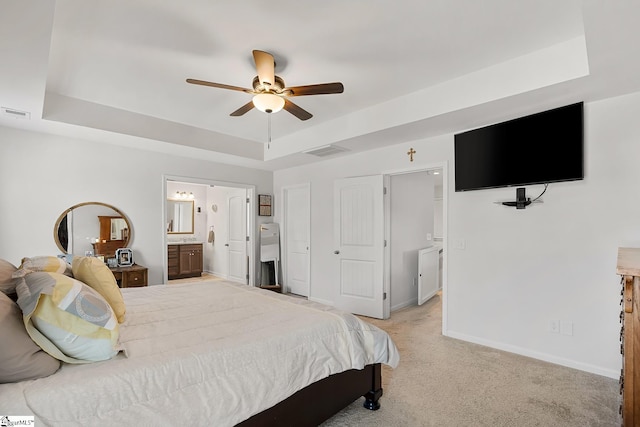 121 Frost Flower Way, Fountain Inn, SC 29644 - bedroom featuring a raised ceiling, light carpet, baseboards, connected bathroom, and a ceiling fan